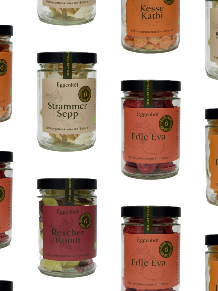 A collection of Eggenhof jars filled with different kinds of spices.